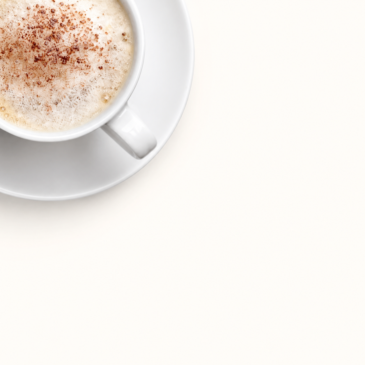 A foamy cappuccino on a white saucer, ready for a writing session