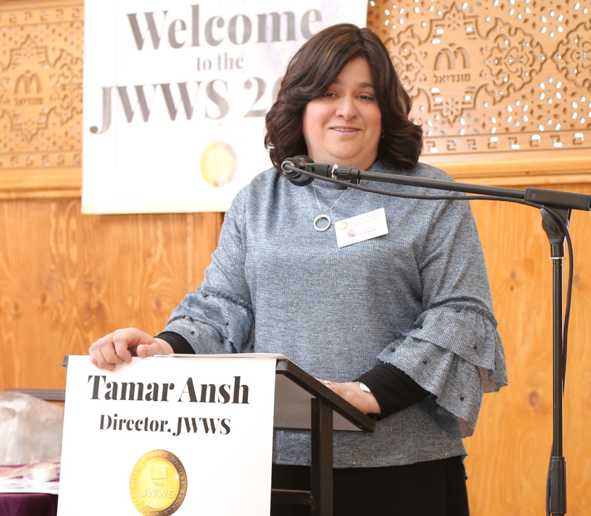 Tamar Ansh speaking at the podium at the JWWS seminar